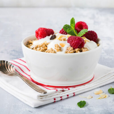A white bowl filled with oatmeal and fresh berries.