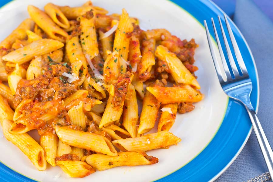 Mostaccioli with penne pasta, a red sauce and hamburger meat- topped with cheese