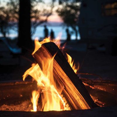 A campfire by a lake