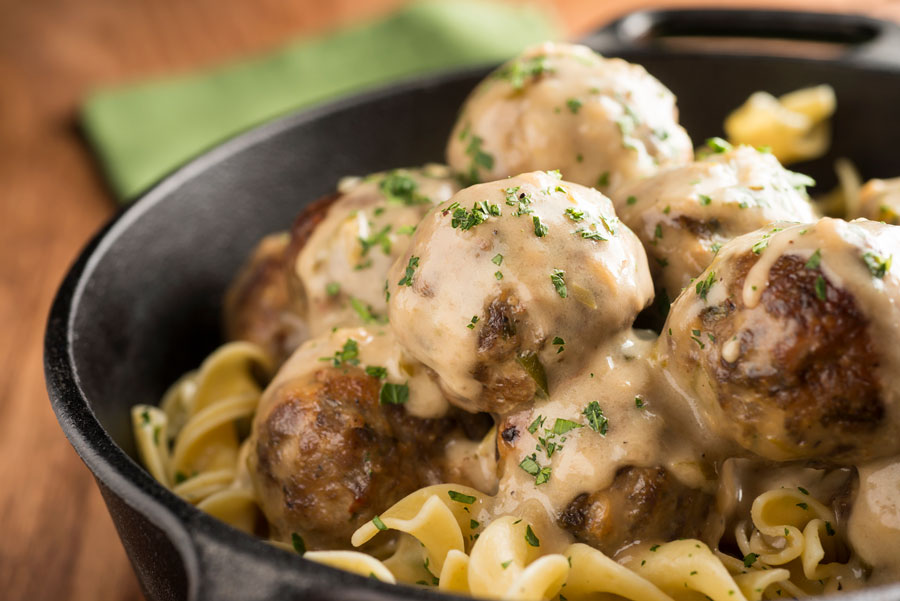 Bowl of egg noodles covered with venison swedish meatballs