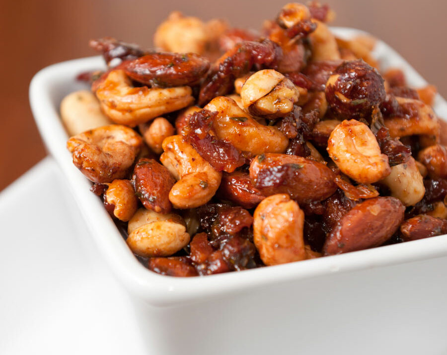 A bowl fulled of nuts with spices.