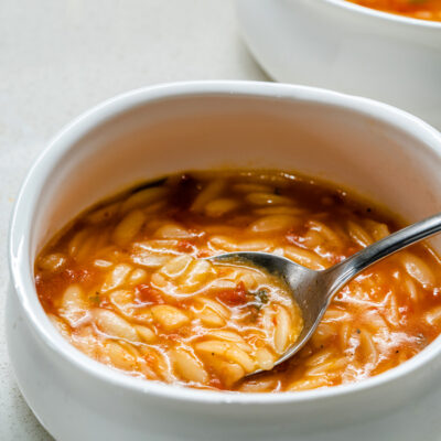 A bowl of tomato soup with orzo