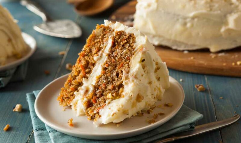 A piece of carrot cake on a white plate