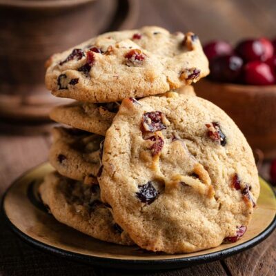 Cherry walnut cookies stacked on a plate.